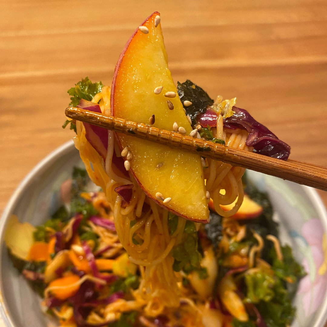 Bibimguksu with salty seaweed strips and ripe juicy peach